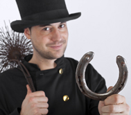 Chimney Sweep holding a brush and lucky horseshoe