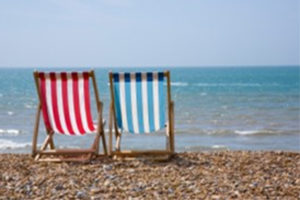 Deckchairs on a pebble beach by the sea