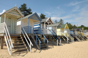 Beach huts with sand dunes at Holkham Beach in Norfolk, England